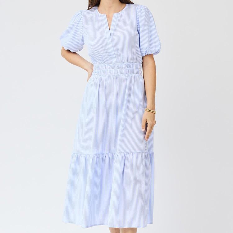 Woman wearing a blue and white striped dress on a white background