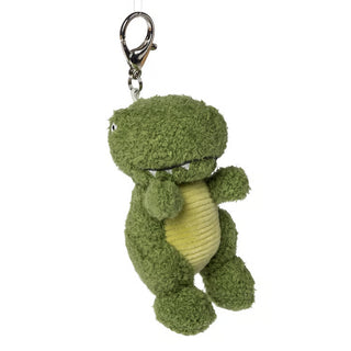 green bag charm shaped like a plush t-rex