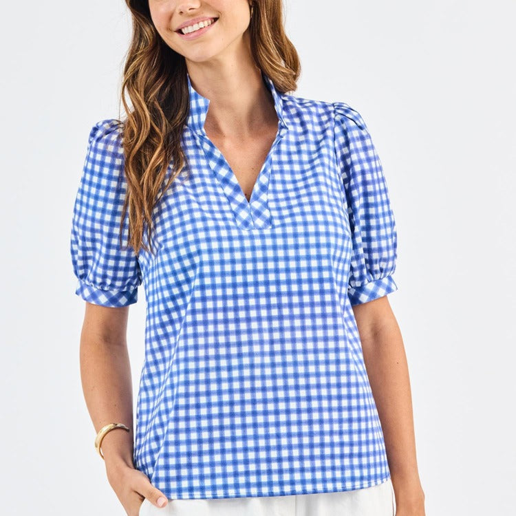 Woman wearing a blue and white checkered blouse on a light gray background