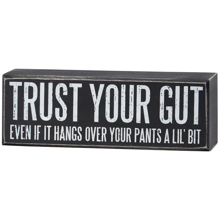 Black box sign with white text 'Trust Your Gut' on a white background