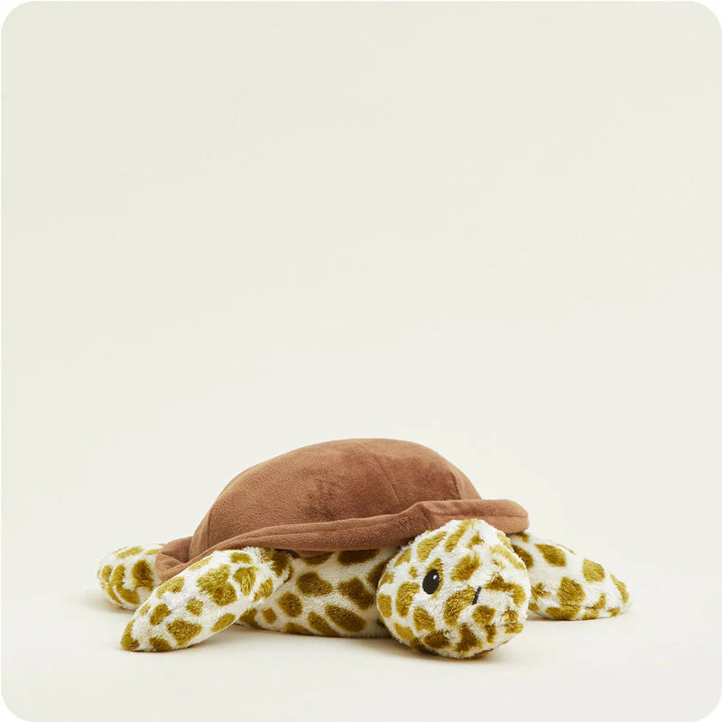 Plush turtle toy with brown shell and spotted pattern on a white background