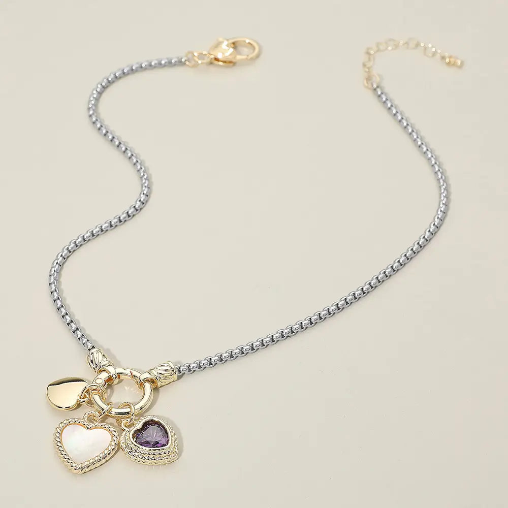 Necklace with heart-shaped charms on a beige background