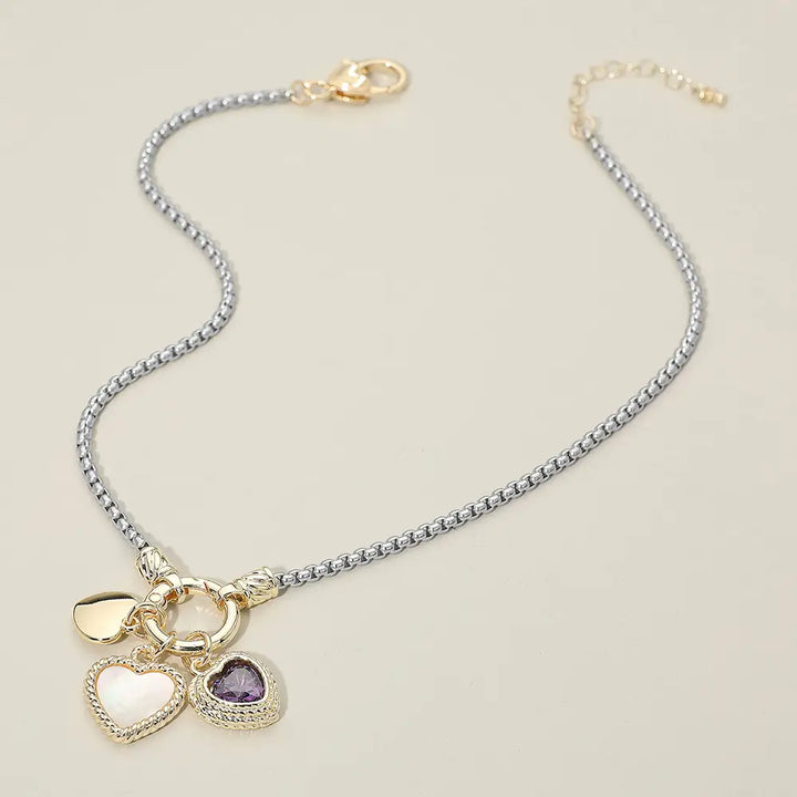 Necklace with heart-shaped charms on a beige background