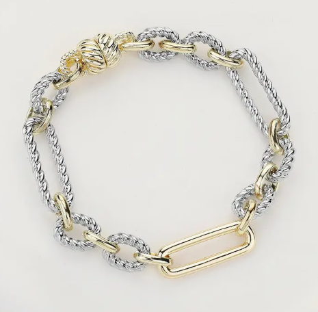 Two-toned chain bracelet with gold and silver links on a white background