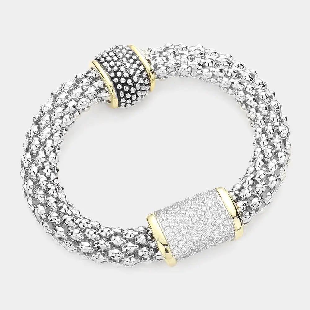 Silver bracelet with gold accents on a white background