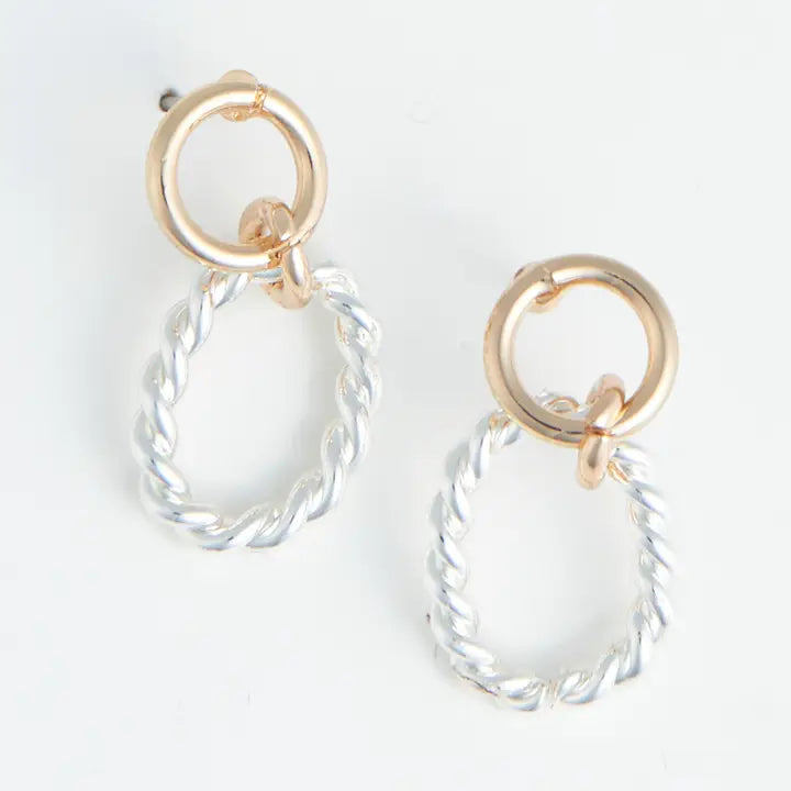 Pair of earrings with gold loops and clear hanging elements on a white background