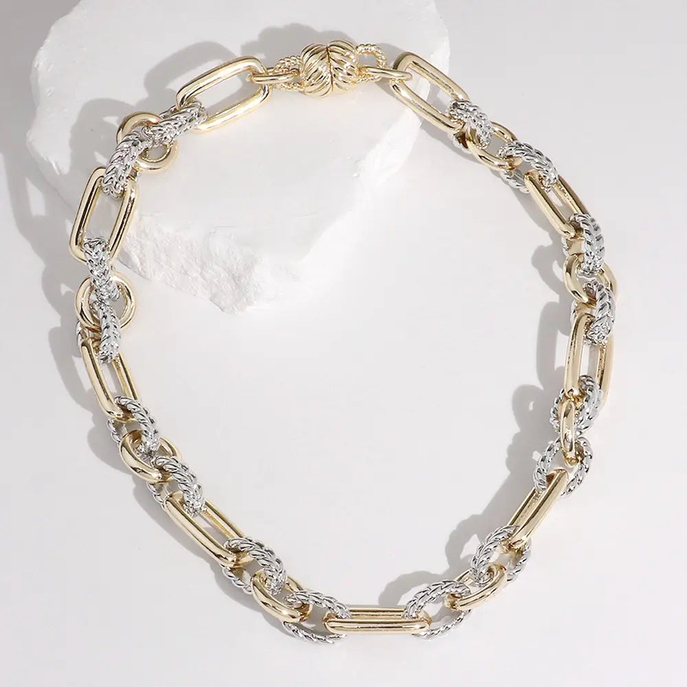 Gold chain bracelet on a white background