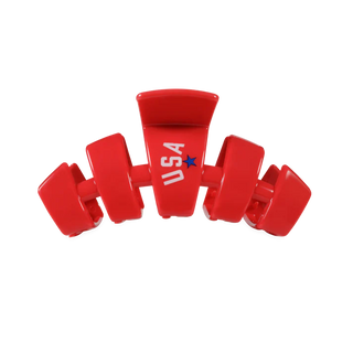 Red hair clip with 'USA' and star emblem on a white background