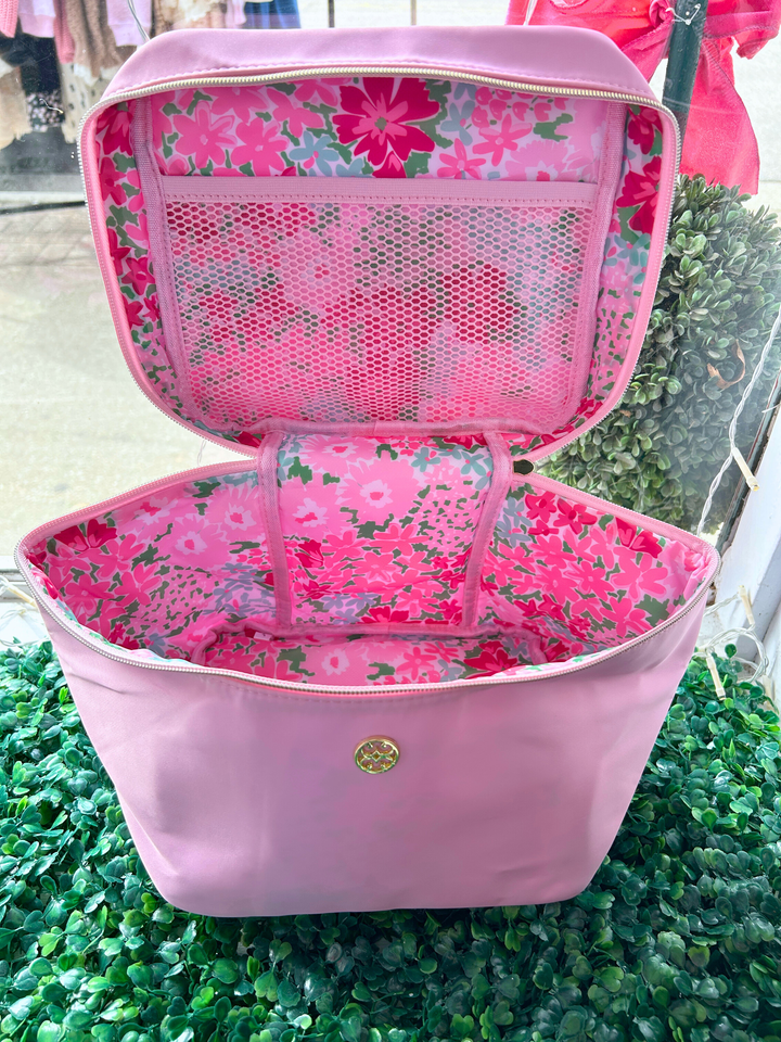 Pink bag with floral interior on a green grass background