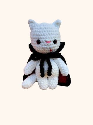 White crochet cat plush toy with black accents on a white background