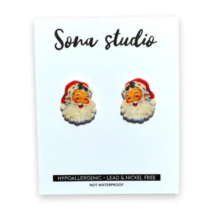 Sonia Studio earrings featuring Santa Claus on a white card with brand name.