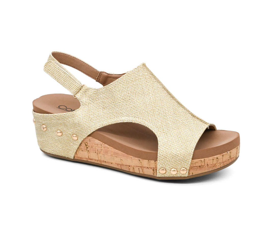 Beige wedge sandal with brown sole on a white background