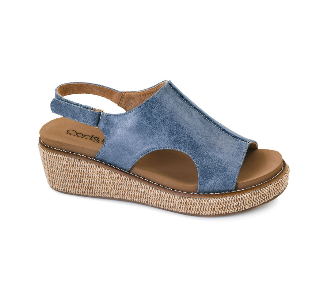 Blue wedge sandal with brown sole on a white background