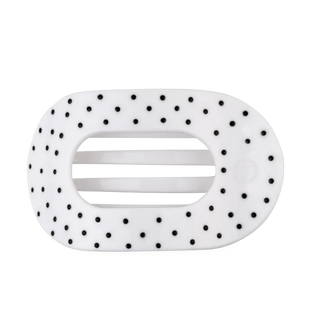 white oval shaped hair clip with black polka dots