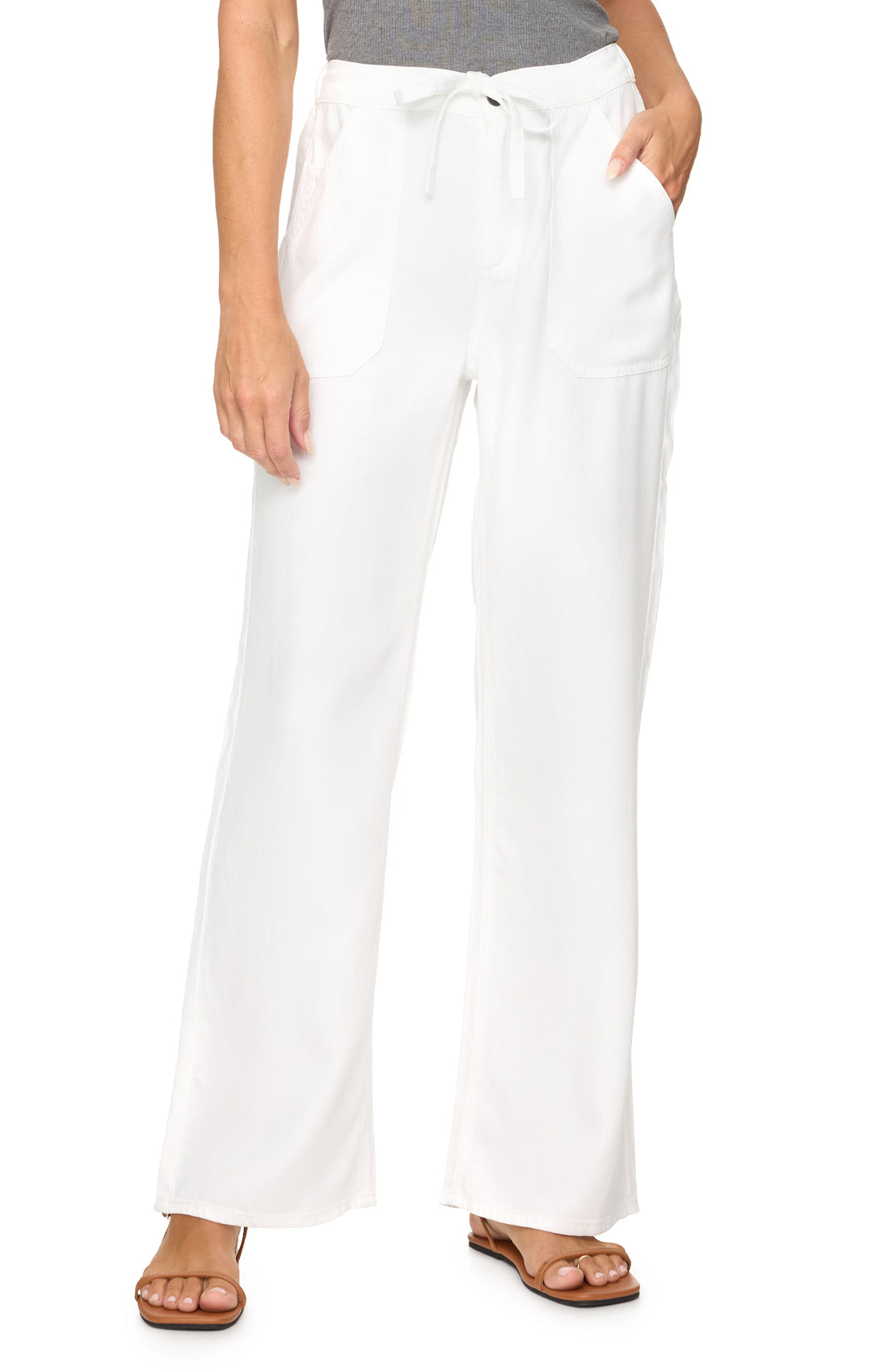 White pants worn by a person on a white background