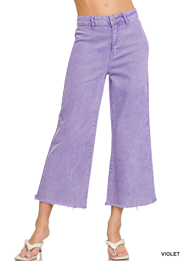 Purple wide-leg jeans worn by a person on a white background