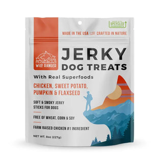 Wild Ranger Jerky Dog Treats in a 6 oz resealable stand-up pouch. The packaging is white with orange, black, and blue graphics, featuring a mountain and hiker illustration.