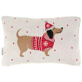 Decorative pillow with a dog wearing a red sweater and Santa hat on a white background