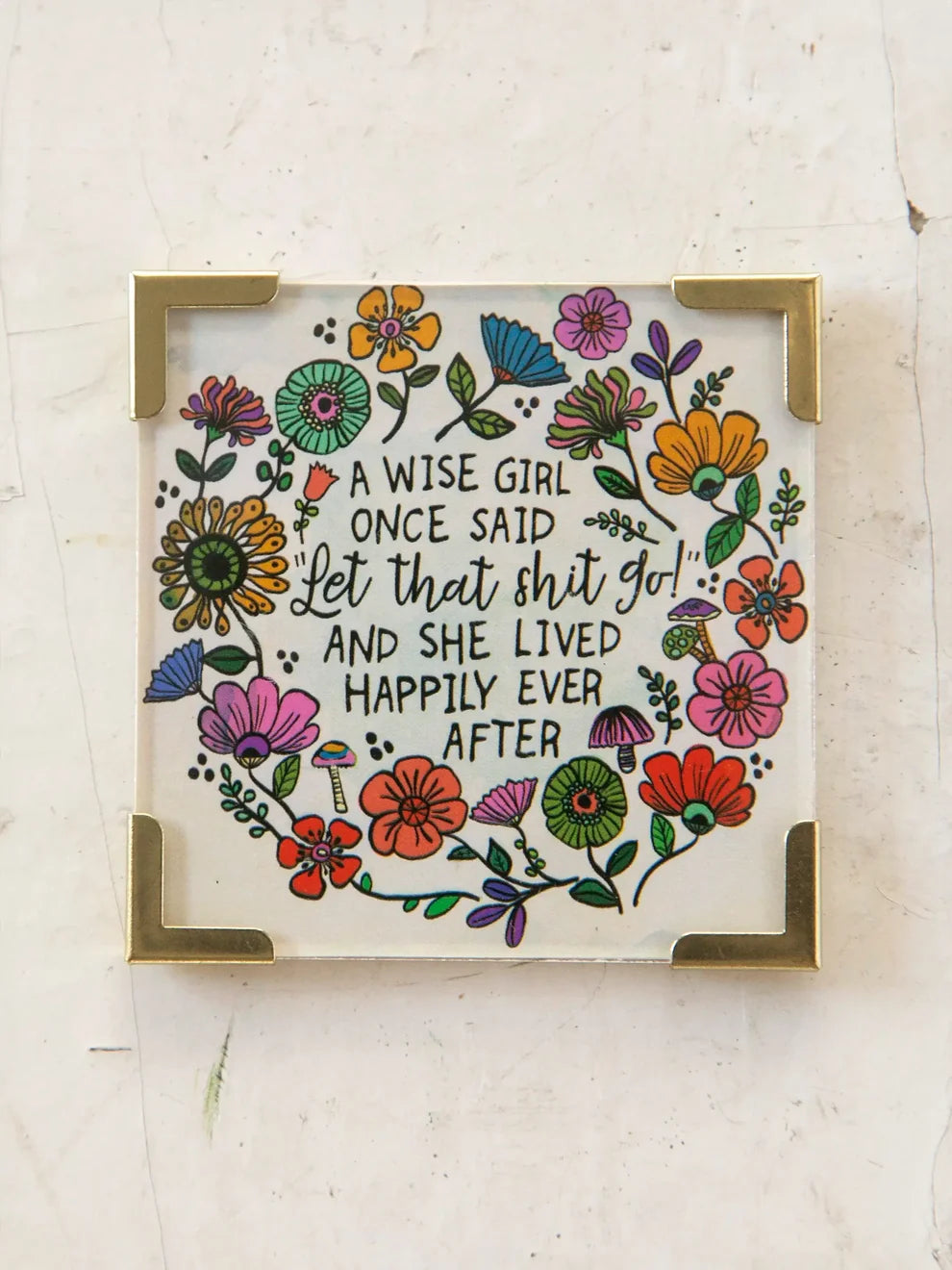 magnet with floral design circled around a saying