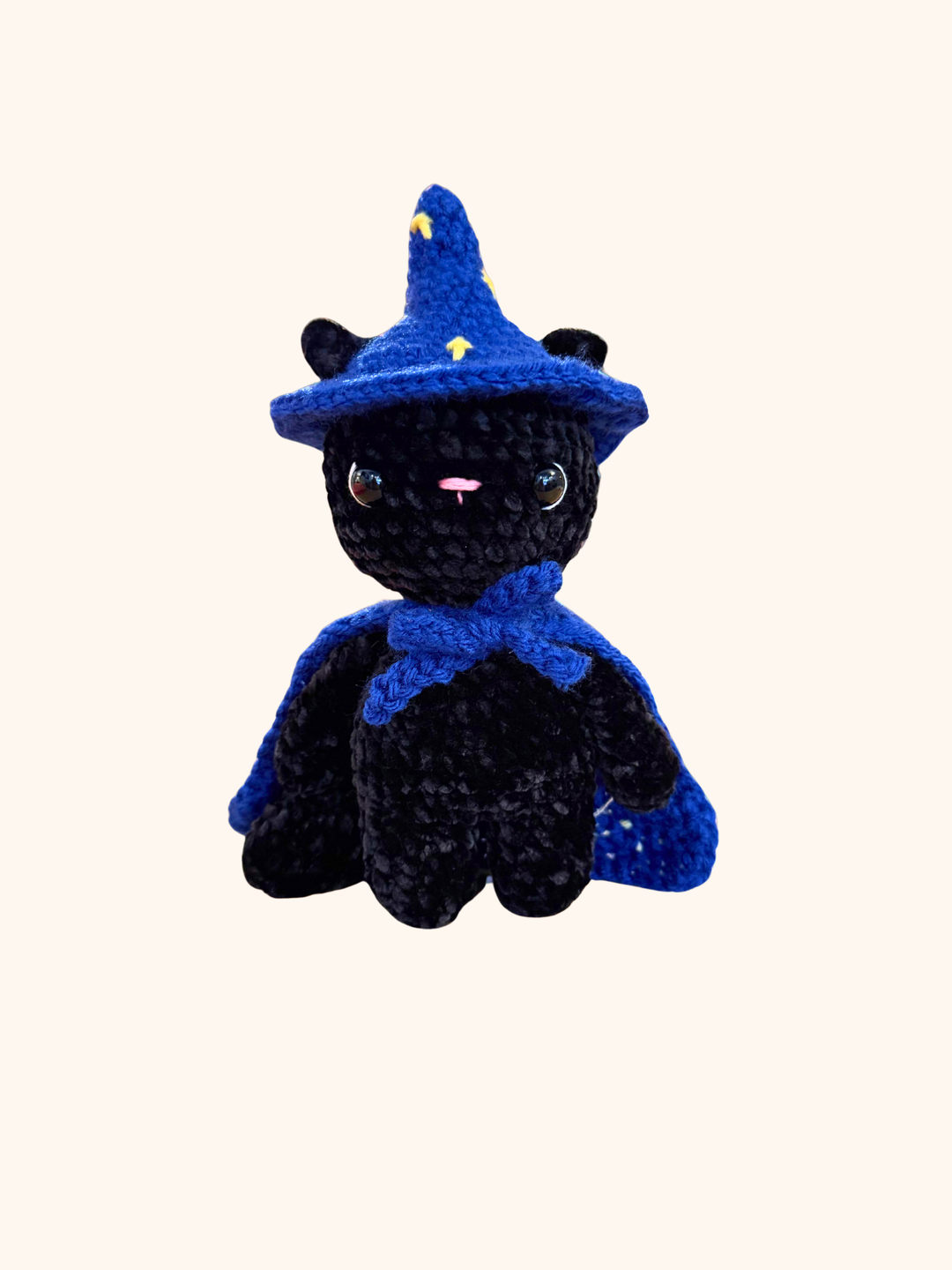 Black cat plush toy with a blue wizard hat on a white background