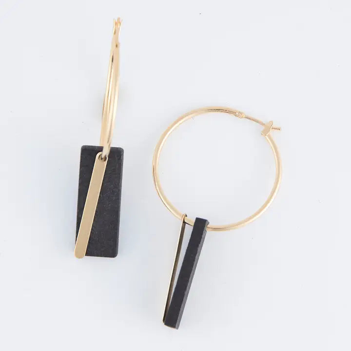 Gold hoop earrings with black bar pendants on a white background