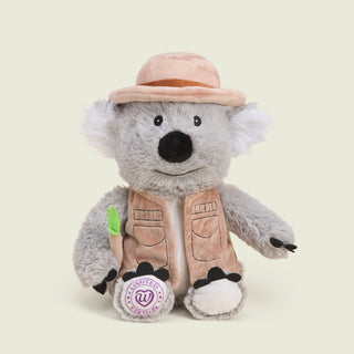 plush koala with brown vest and hat and a piece of bamboo in hand. 