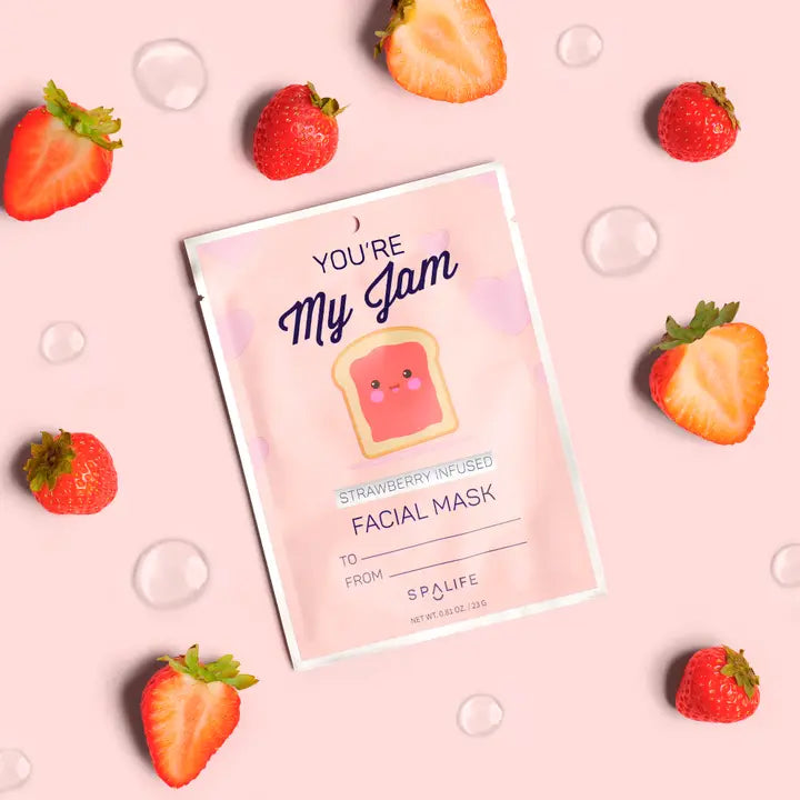Facial mask packaging with strawberries on a pink background
