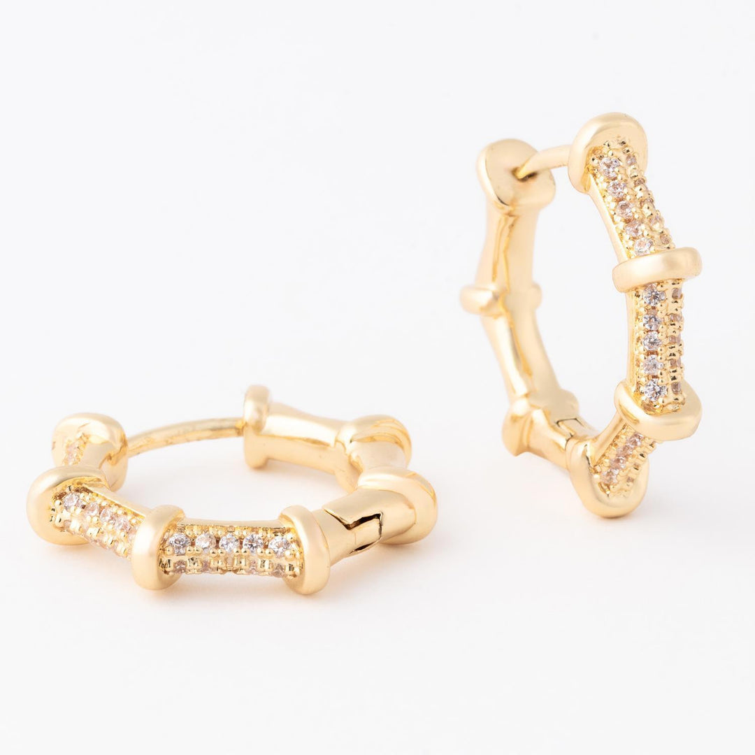 Gold hoop earrings with diamond accents on a white background
