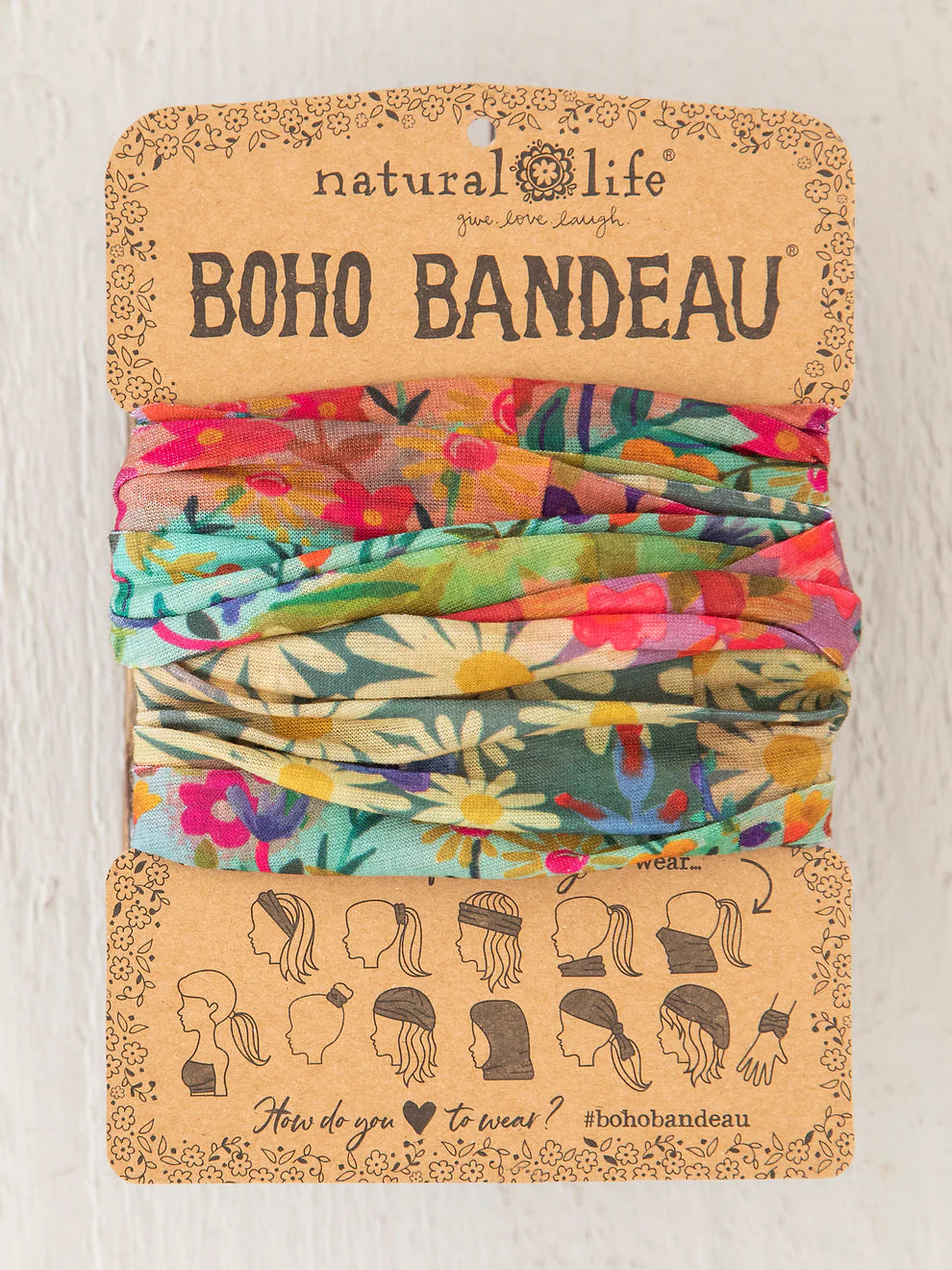 Colorful boho bandeau on a natural life branded card with patterns and icons.