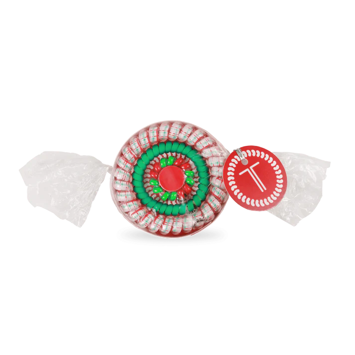 Decorative candy with a red and green center and white shell on a white background
