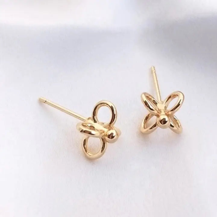 Gold butterfly-shaped earrings on a white background