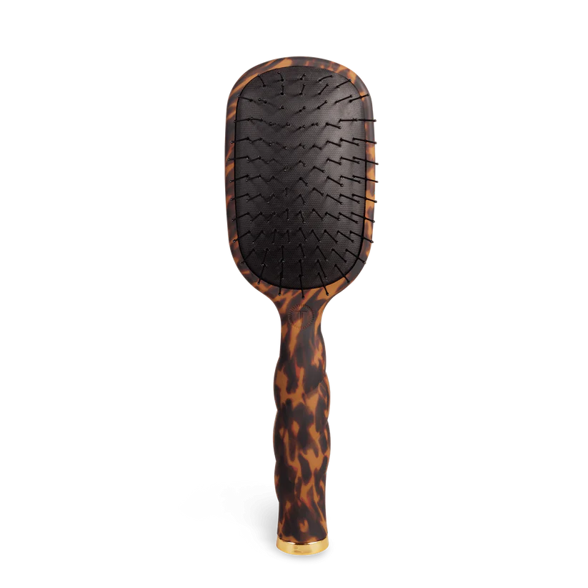 Hairbrush with tortoiseshell handle on a white background