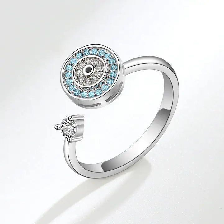 Silver ring with blue gemstones and a diamond on a white background