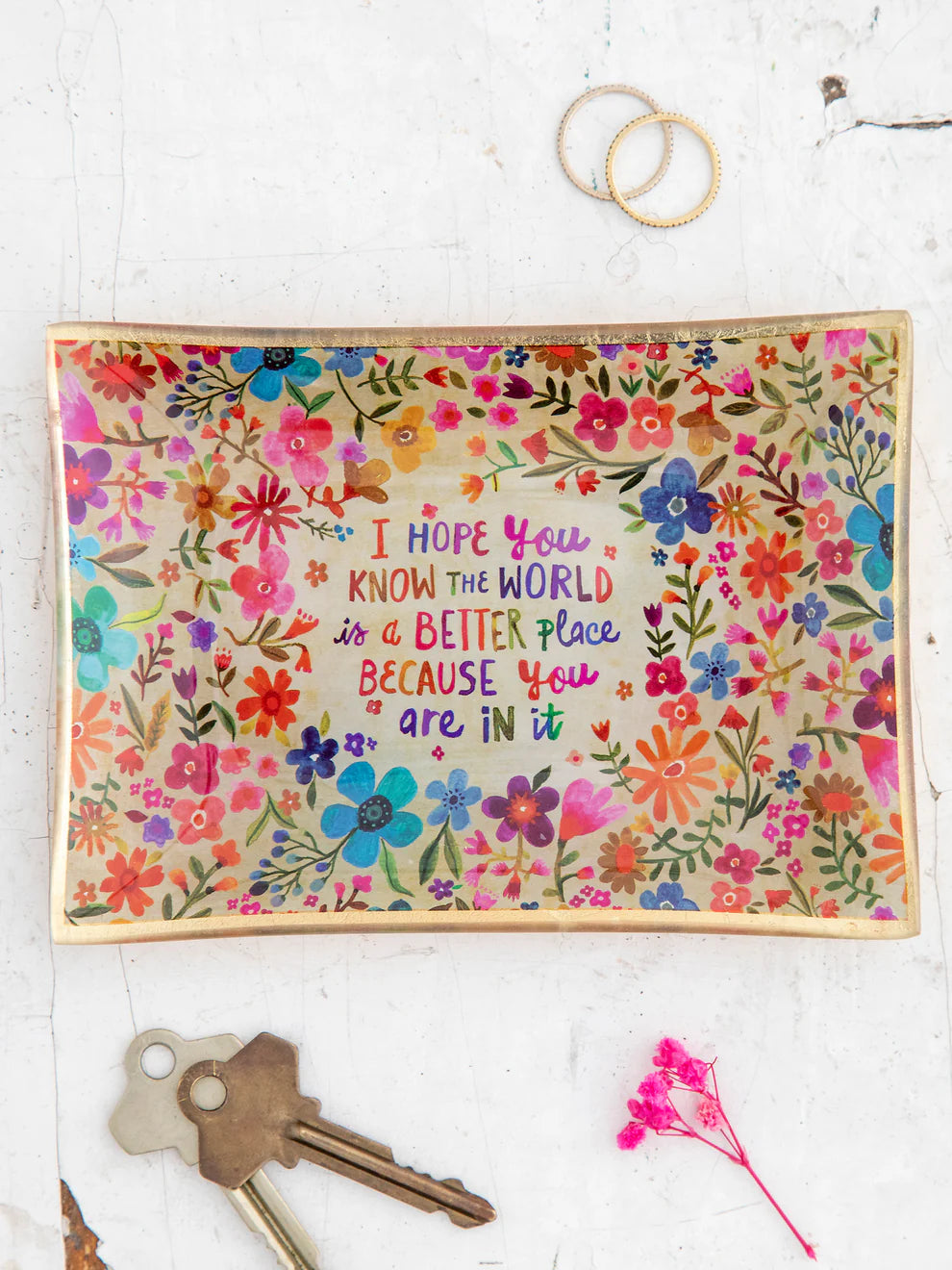 Colorful floral poster with motivational quote on a white background with keys and a ring.