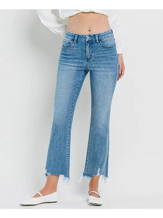 Person wearing light blue jeans on a white background