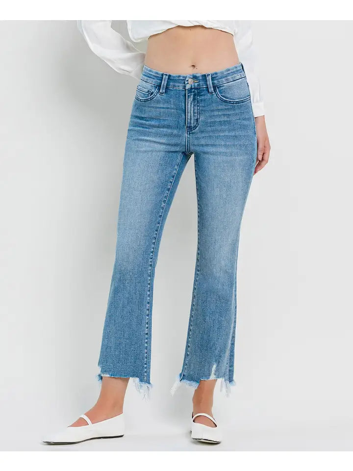 Person wearing light blue jeans on a white background