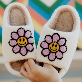 white slippers with purple daisy design