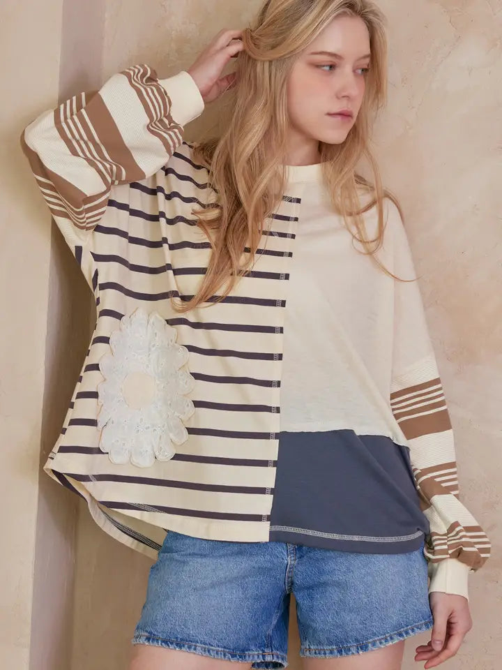 Patchwork long sleeve top with different stripe patterns and a lace flower detail
