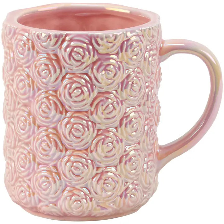 Pink ceramic mug with rose pattern on a white background