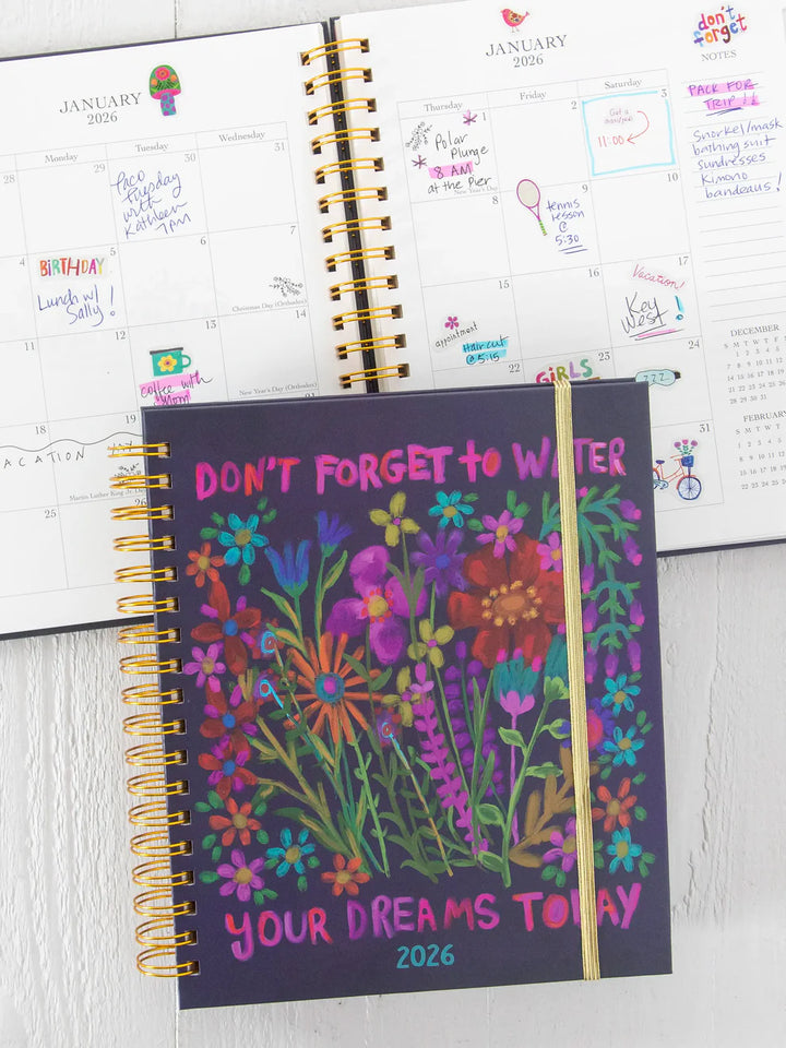 Notebook with floral design and motivational quote on a white surface