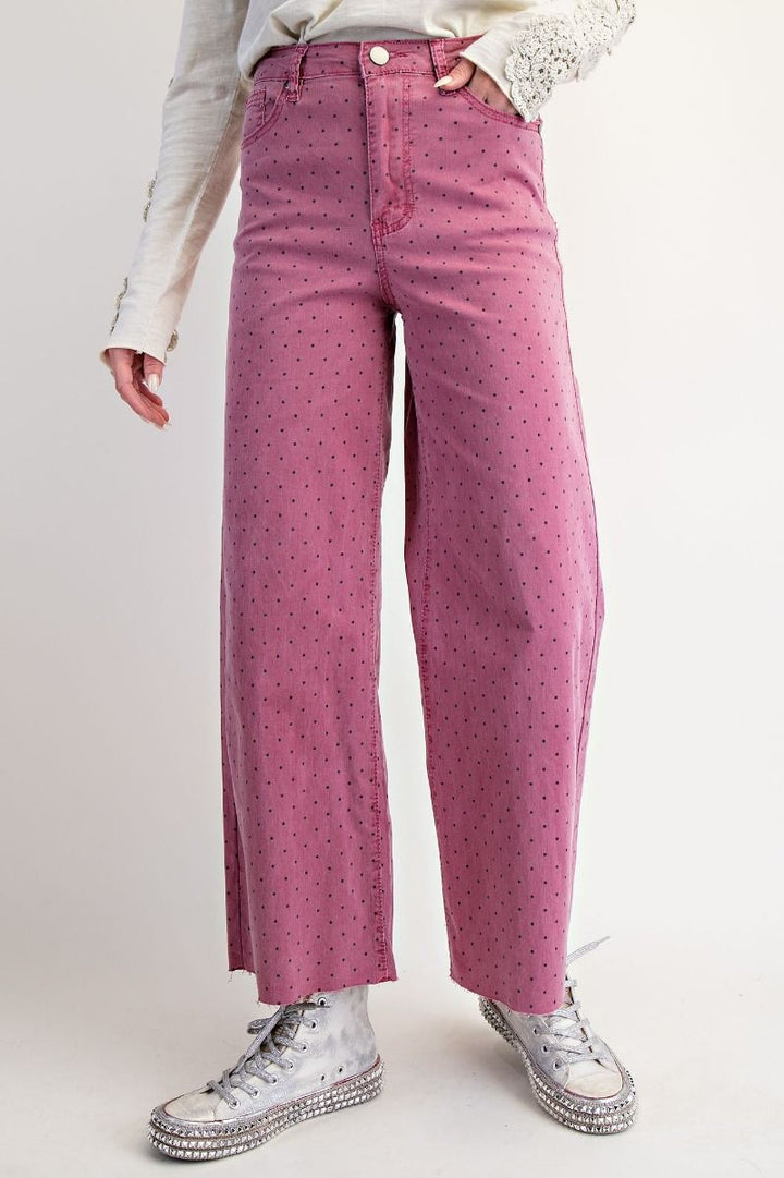 Person wearing pink patterned pants with a white background