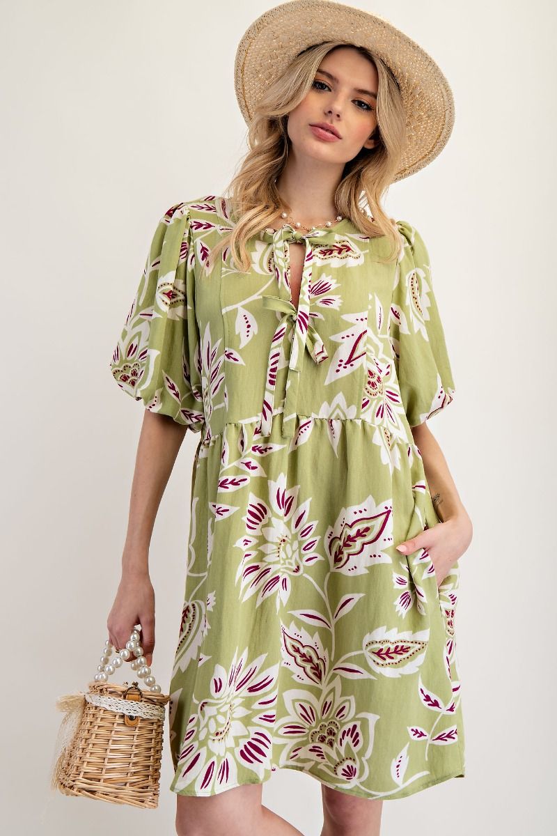 sage green midi dress with v-neck cut, and bubble sleeves. The dress has a floral design and double ribbon enclosure around the neckline