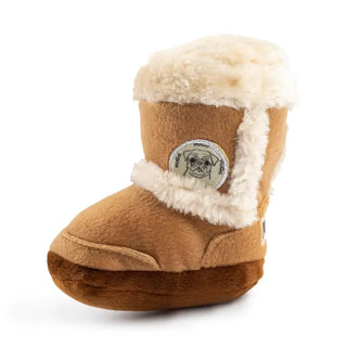 A plush dog toy resembling a boot with a squeaker inside, primarily beige in color with brown accents and a white pom-pom.