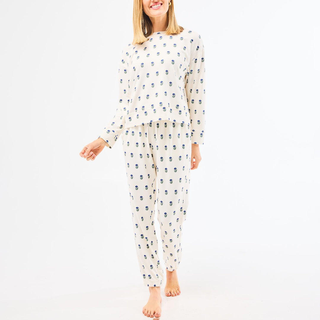 Woman wearing a patterned pajama set on a white background