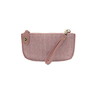 Pink woven handbag with a strap on a white background