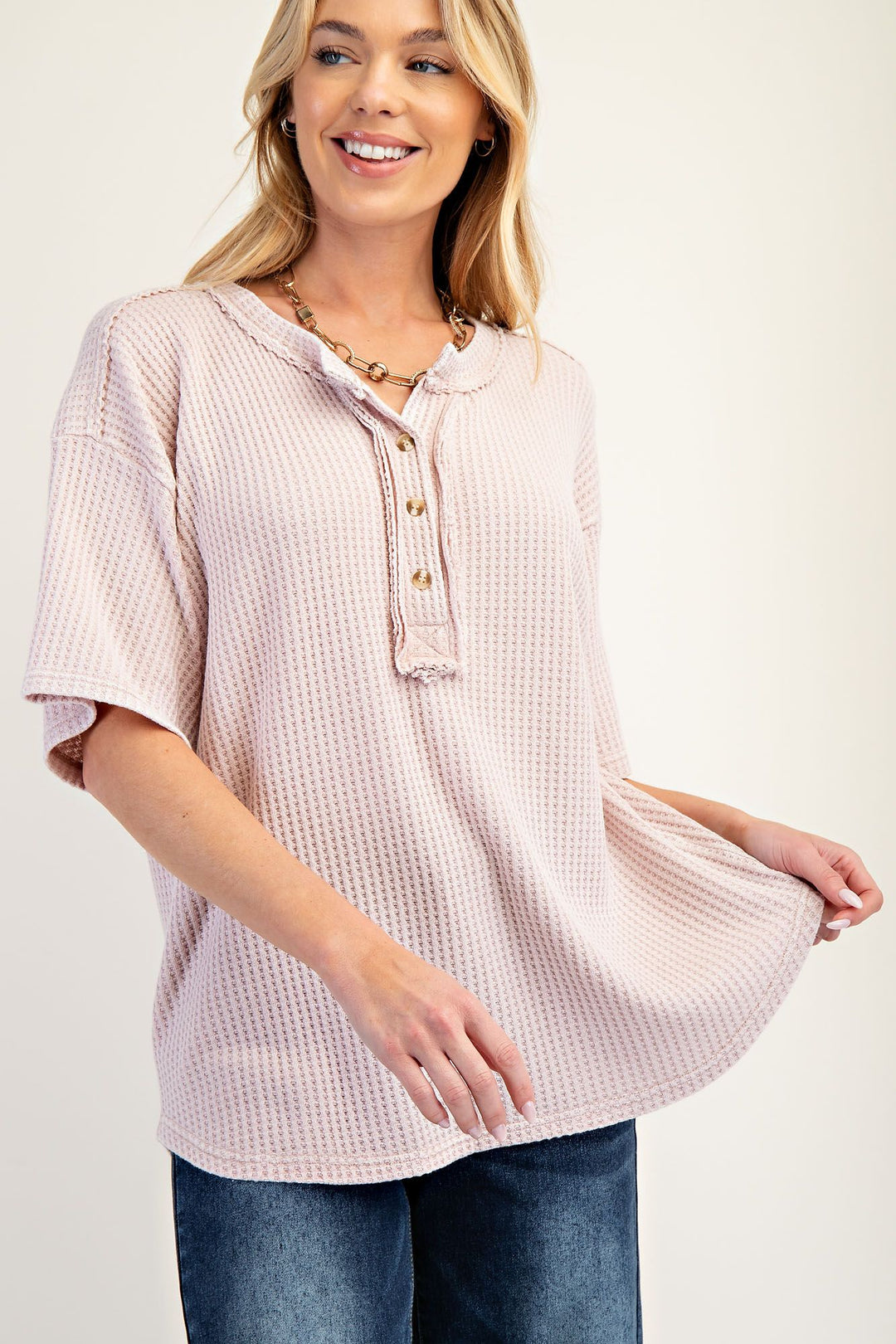 light pink thermal knit short sleeve drop shoulder top with button closures