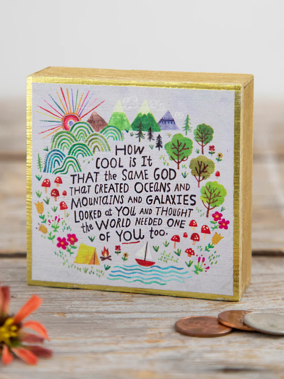 Decorative box with a colorful illustration and text on a wooden surface