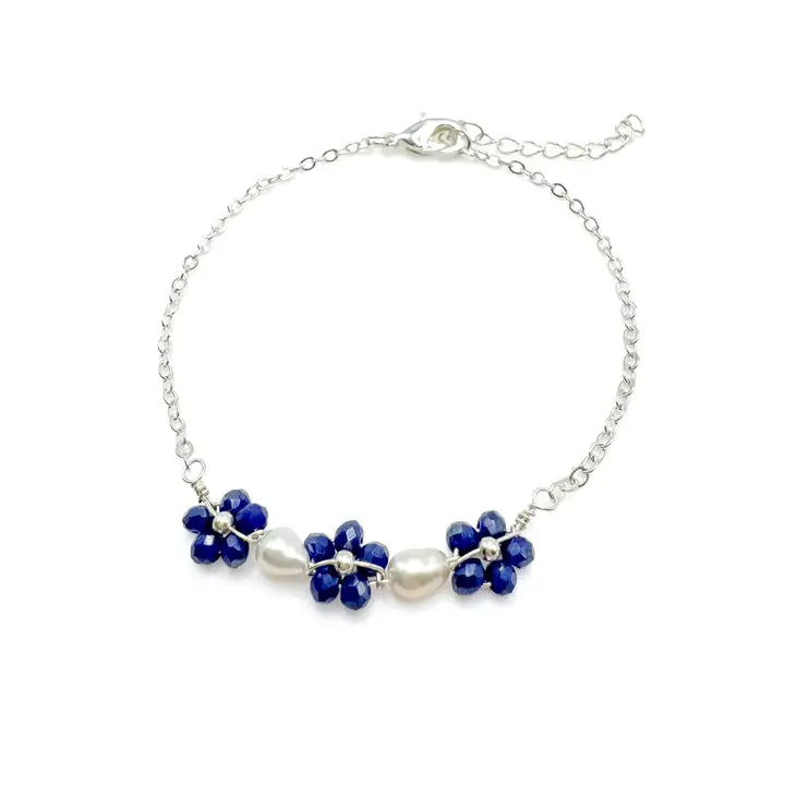 silver bracelet with blue beaded flower details