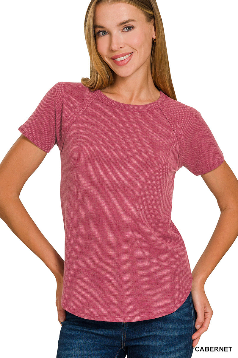 Woman wearing a red waffle knit t-shirt 