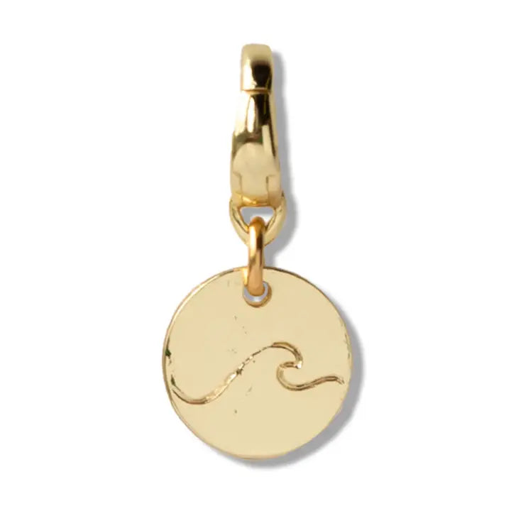 Gold pendant with a wave design on a white background
